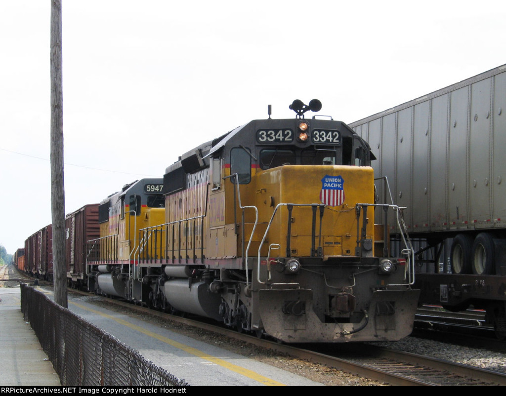 UP 3342 brings a train in beside the tower